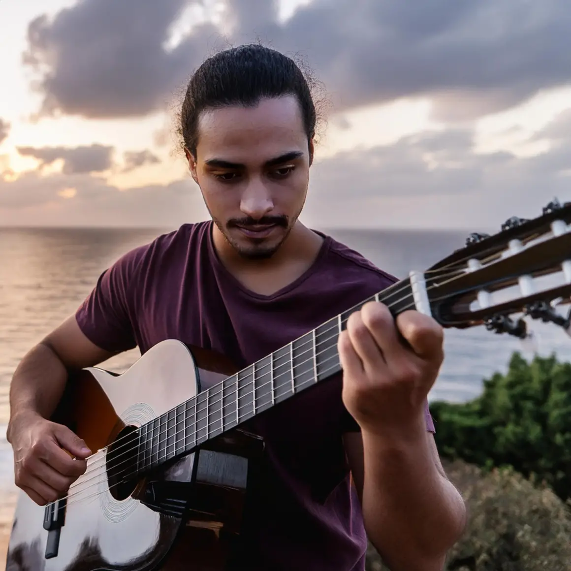 Man playing an acoustic guitar by ocean at sunset prompt output 1
