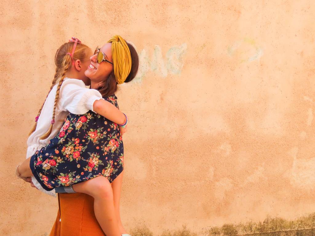 mum carrying daughter