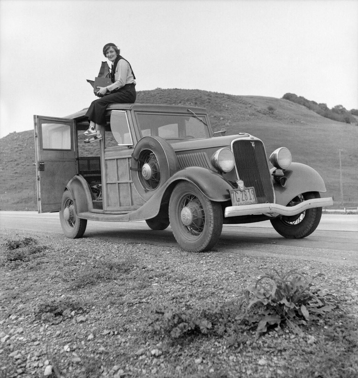 dorothea lange on a ford model 40 with a camera