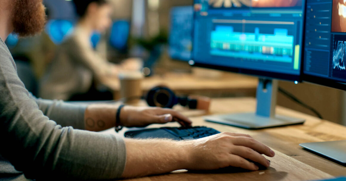 videographer editing at a computer