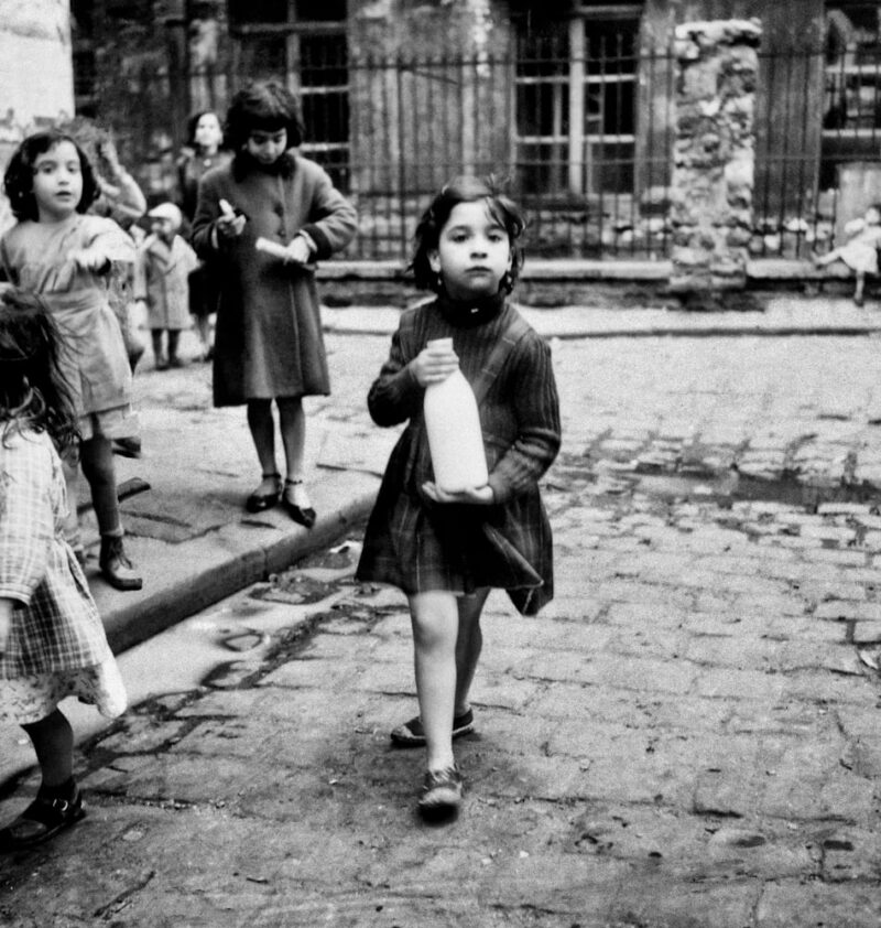 Girl with milk bottle Cite Lesage Bullourde Paris c1950 © Marilyn Stafford