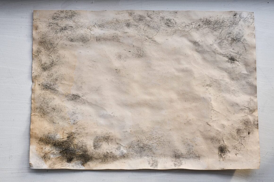 Tea stained baked paper with charcoal dust