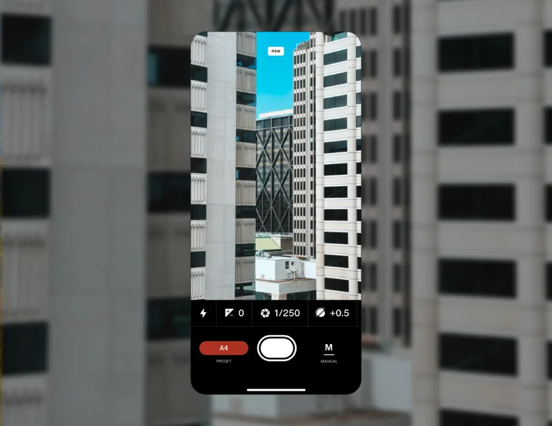 a screenshot of a phone with the vsco capture app is placed against a cityscape