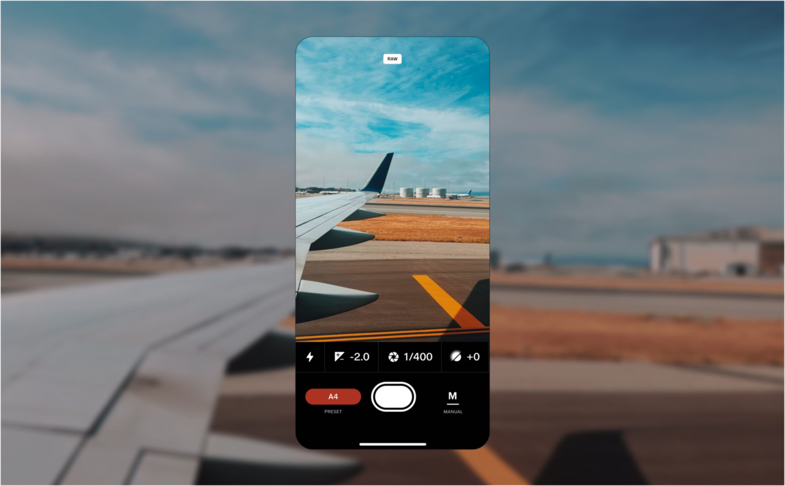 a screenshot of phone with the vsco creator app is placed against a photo of an airplane on a runway scaled