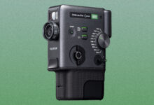 a fujifilm hybrid camera is on a green background