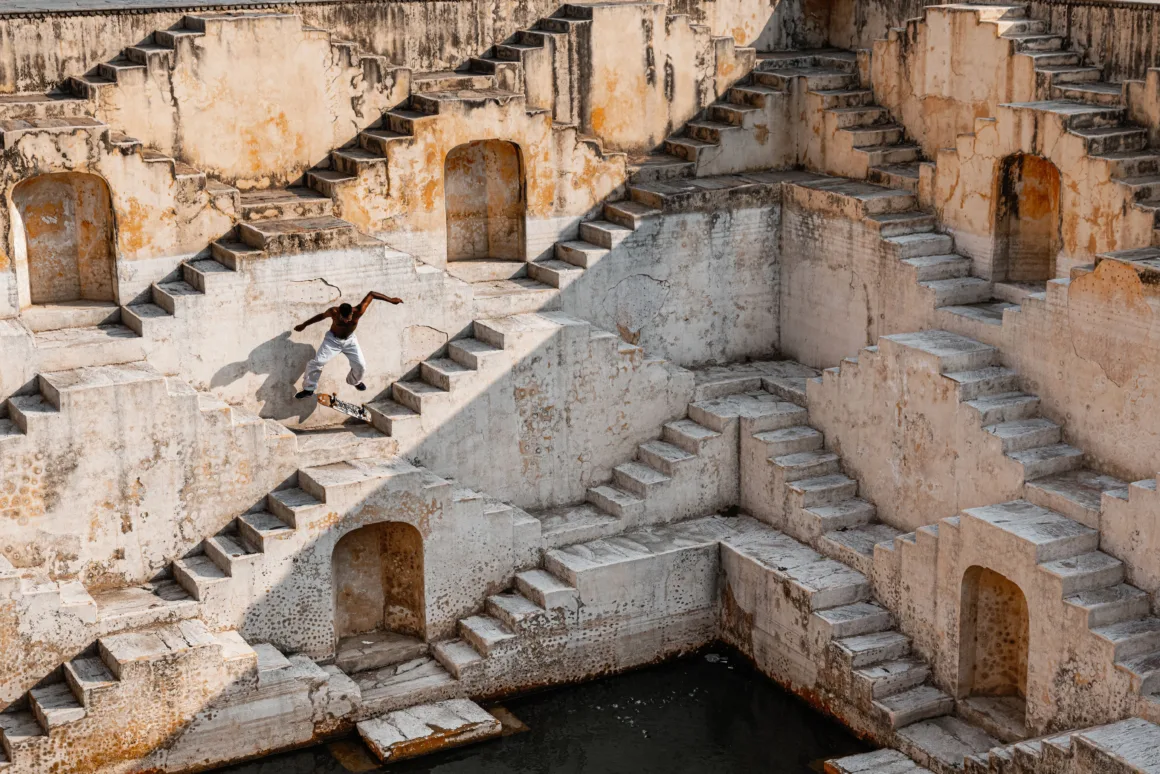 a person skateboards amidst a wall of stairs and doorways