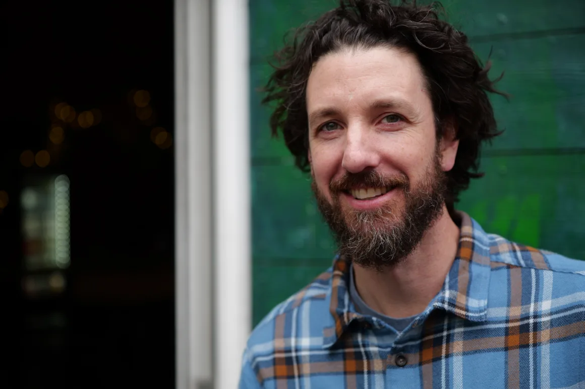portrait of a man standing outside a building