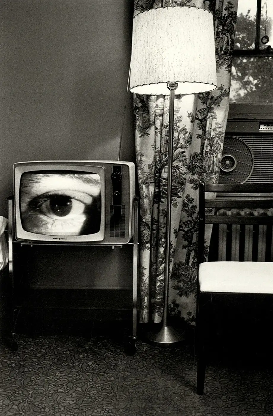 Lee Friedlander layered street scene with reflections and urban surfaces