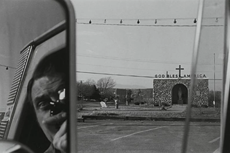 Lee Friedlander black and white street photograph with layered urban reflections