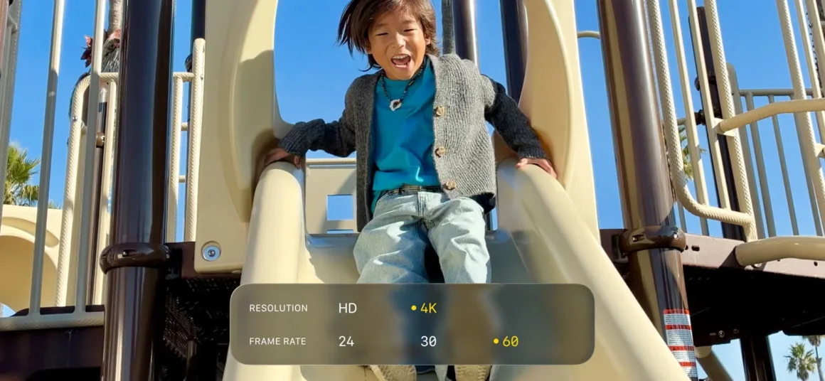 Apple iPhone 17e’yi Tanıttı: A19 Çip, 48 MP Fusion Kamera ve MagSafe Desteği 9 Neşeli bir ifadeye sahip bir çocuk oyun parkındaki kaydıraktan aşağı kayıyor. Ekran üzerinde video ayarları görünüyor: çözünürlük seçenekleri **HD** ve **4K**, kare hızı seçenekleri ise **24, 30 ve 60 fps** olarak gösteriliyor.