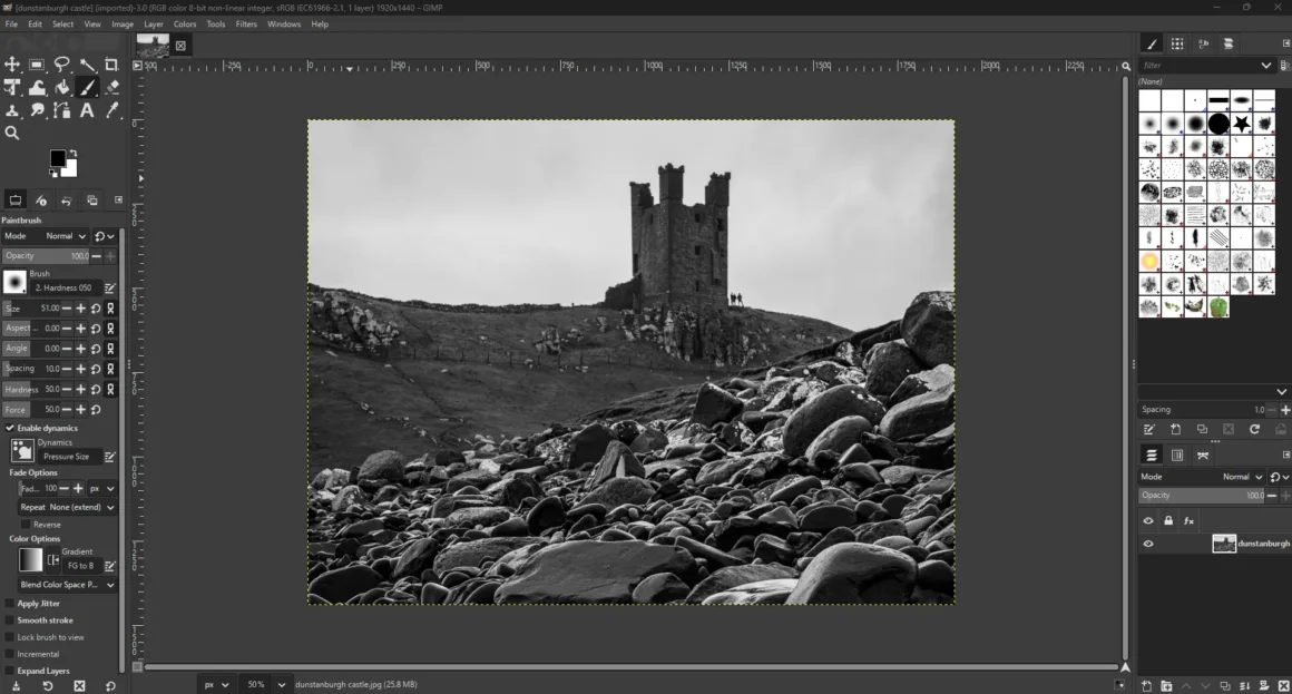 Kayalık bir manzara ve tepede eski, yıkılmış bir taş kuleyi gösteren siyah beyaz bir fotoğrafın, etrafında araç çubukları ve paneller bulunan GIMP yazılımında düzenleme ekranında açık hali.