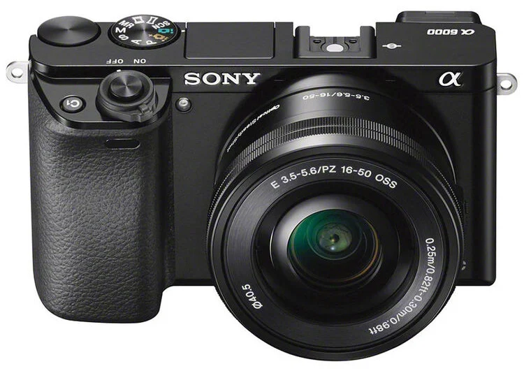 16-50mm zoom lens takılı siyah Sony Alpha a6000 aynasız dijital kamera; marka detayları ve kontrol düğmeleri görünür şekilde önden gösteriliyor.