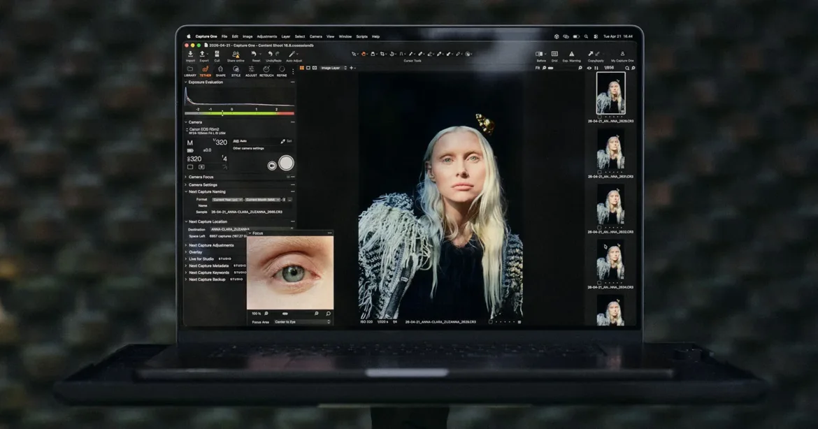 A laptop screen displays the Capture One software interface, showing a portrait of a blonde woman and a close-up focus tool of her eye.