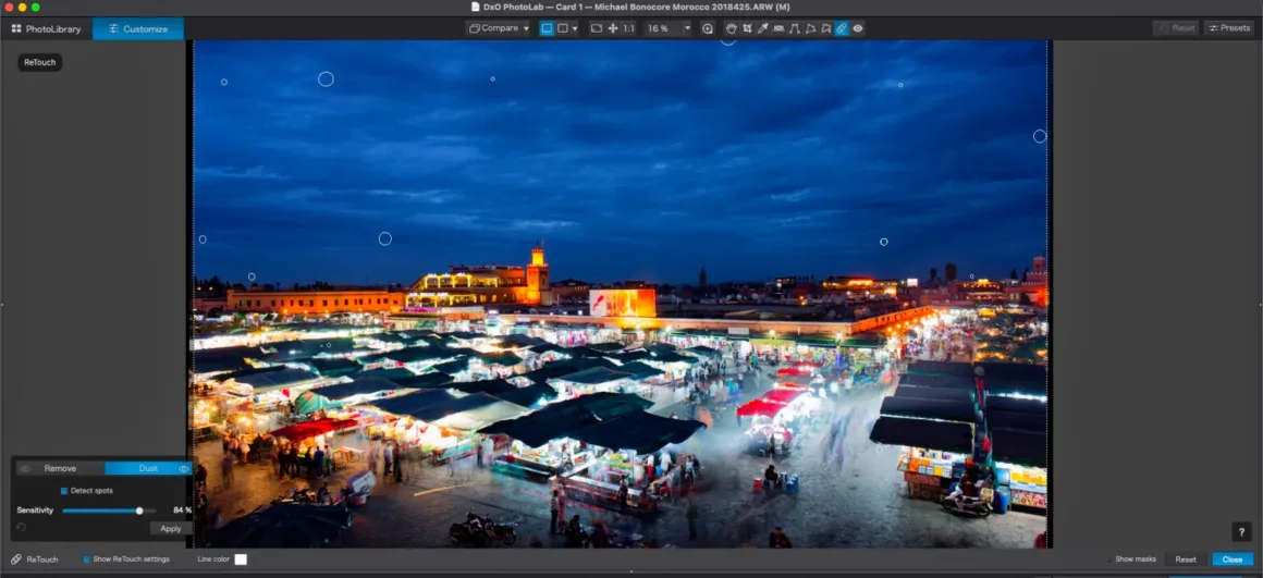 DxO PhotoLab 10: Yaratıcı Kontrolden Vazgeçmeden Daha Hızlı RAW Düzenleme 33 Yazılım arayüzünde bir gece pazarı sahnesi gösteriliyor; gökyüzü ve tezgâhların üzerinde dairesel rötuş işaretleri bulunuyor.