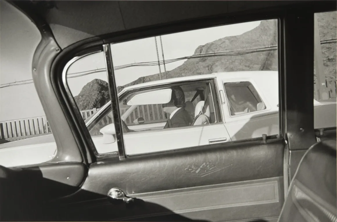 Henry Wessel: Direksiyon Başından 1980’lerin Kaliforniya’sı 19 Bir otomobilin içinden, yan şeritte ilerleyen beyaz otomobil ve sürücüsüne bakış.