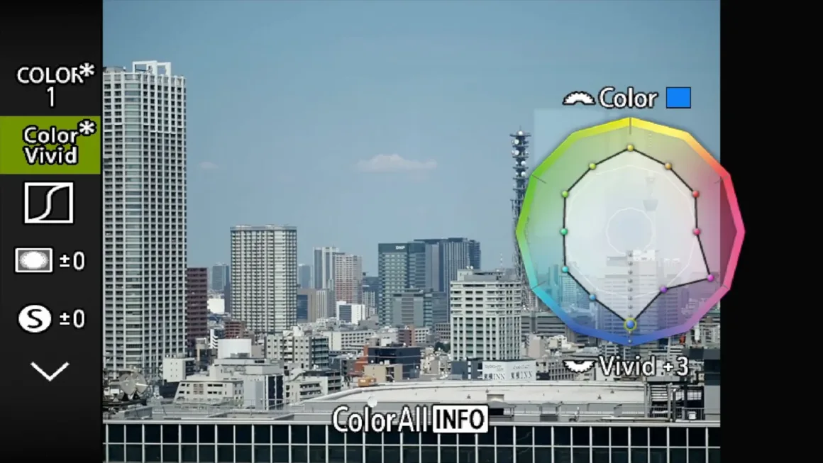 OM System PEN İncelemesi: Tanıdık Ama Son Derece Şık 28 A digital camera menu overlay displays color settings over a cityscape, featuring a color adjustment wheel with a "Vivid +3" setting selected.