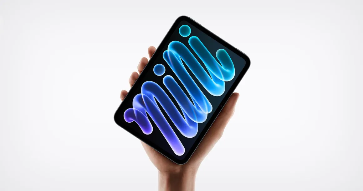 Yeni iPad mini Tanıtıldı: OLED Ekran, A20 Pro ve Daha İnce Tasarım
Bir el, beyaz arka plan önünde ekranında soyut mavi ve parlak şerit benzeri bir grafik bulunan küçük bir tableti tutuyor.